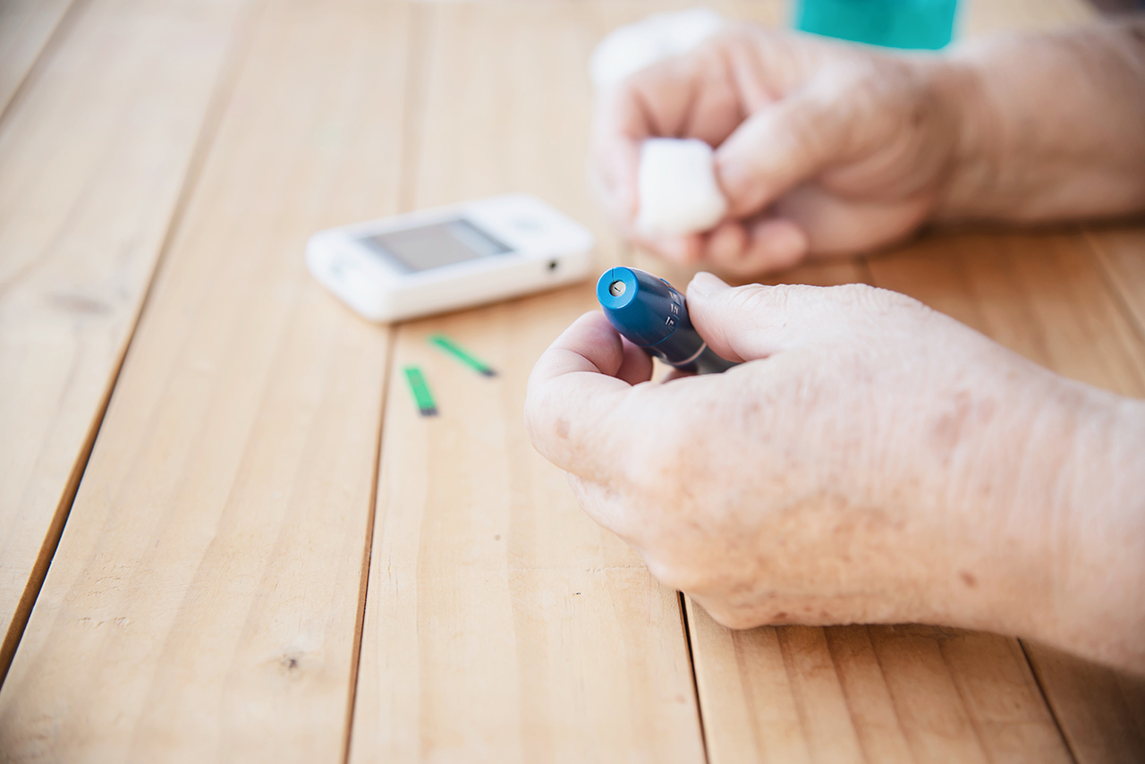 old-lady-is-testing-blood-sugar-level-using-blood-sugar-test-kid-set.jpg